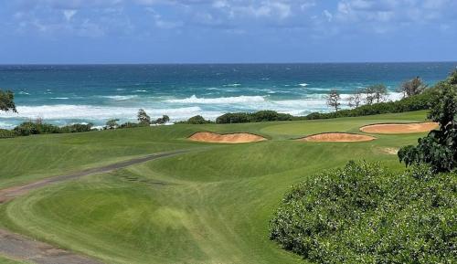 a green golf course with the ocean in the background at "Island Time" at Plantation Hale D4 in Kapaa