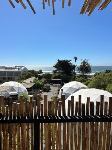 a wooden fence with a view of the beach at Domos de Matanzas in Matanzas