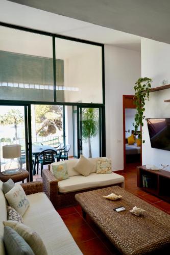 a living room with a couch and a table at Casa Binimel-là con piscina a Cala n'Bosh Menorca in Cala en Bosc