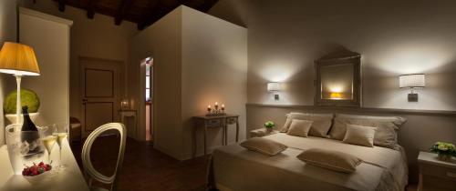 a bedroom with a large bed and a mirror at Le Quattro Terre in Corte Franca