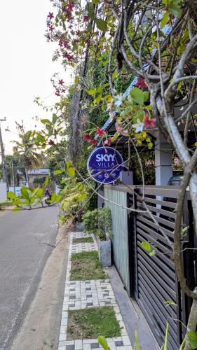 a sign that is on the side of a fence at Skyy Villa matara in Matara