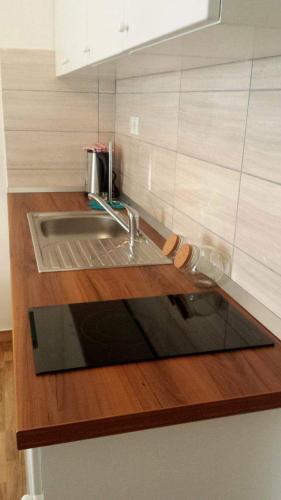 a kitchen with a sink and a counter top at Laganini Apartments in Split