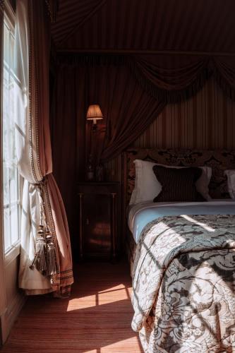 une chambre avec un lit et une fenêtre dans l'établissement L'Hôtel, à Paris