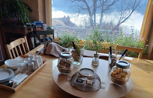 a table with food on it with a view at Gorges du Verdon - Chambres d'Hotes des arches - Cadre magnifique, in Castellane