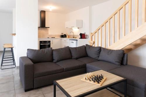 a living room with a couch and chessboard on a table at gîte maison d'Anetz in Anetz