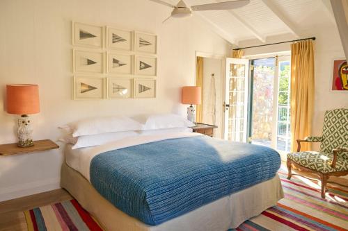 a bedroom with a large bed and a chair at 7 Koppies in Franschhoek