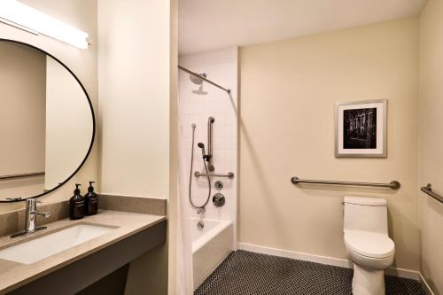 a bathroom with a sink and a toilet and a shower at The Ann Savannah, Apartments by Marriott Bonvoy in Savannah