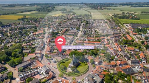 an aerial view of a city with a red sign at Welcome in - Appartementen Pleinzicht, met zonnige balkon I Dorpsplein 6 Koudekerke in Koudekerke