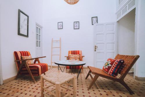 a room with chairs and a table and a ladder at The Loft in Marrakech