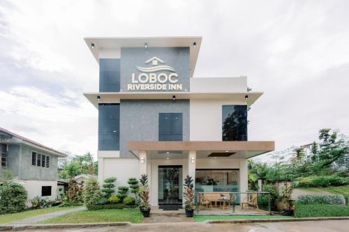 a building with a sign that reads loco mortgage inn at Loboc Riverside Inn & Restaurant in Loboc
