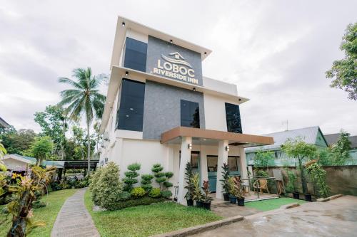 a building with a sign that reads loco architecture at Loboc Riverside Inn & Restaurant in Loboc