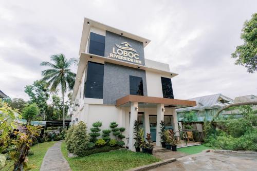 a building with a sign that reads loooc embassy at Loboc Riverside Inn & Restaurant in Loboc
