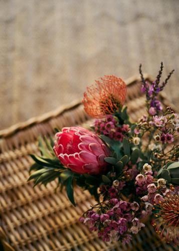 a bouquet of flowers in a wicker basket at 7 Koppies in Franschhoek