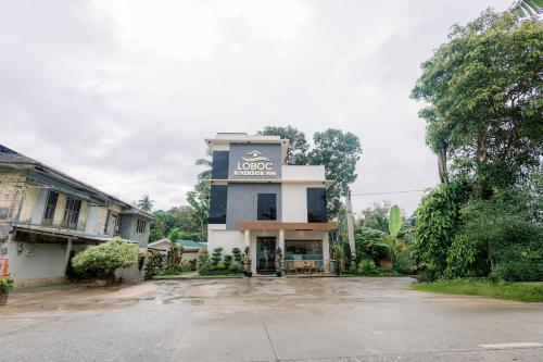 a building with a sign on the side of it at Loboc Riverside Inn & Restaurant in Loboc