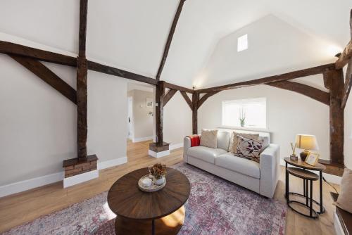 a living room with a couch and a table at Charming cottage with hot tub & private garden in Rochester