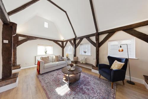 an attic living room with wooden beams at Charming cottage with hot tub & private garden in Rochester