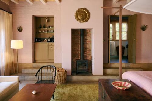 a living room with a couch and a fireplace at 7 Koppies in Franschhoek