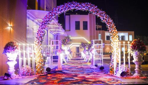 an arch is decorated with flowers and lights at Best Western Swaran Amritsar in Amritsar