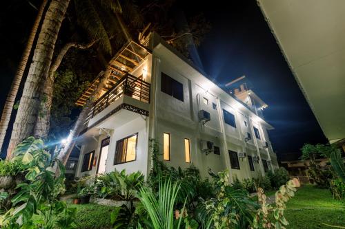a white building with lights on at night at Loboc Riverside Inn & Restaurant in Loboc