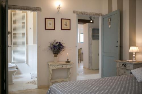 a bedroom with a bed and a candle on a table at Villa Il Nido in Cortona
