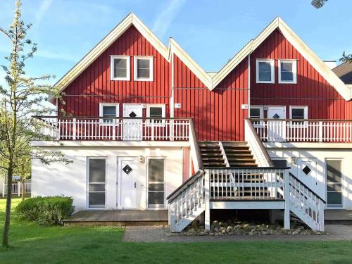 a large red and white house with a porch at Ferienpark Bad Saarow in Bad Saarow