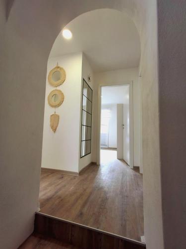 an empty hallway with an archway in a house at Apartment AlpiPond in Kamnik