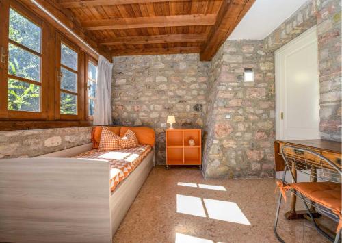 a room with a bed and a stone wall at Le Ravere Luxury Mini-Resort - a structure for 12 in Gargnano
