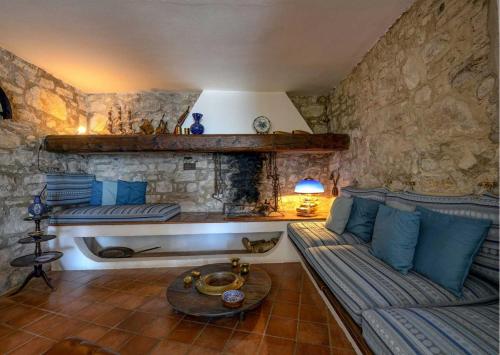 a living room with a couch and a table at Le Ravere Luxury Mini-Resort - a structure for 12 in Gargnano