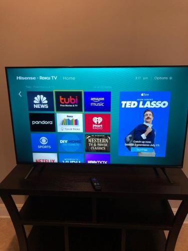 a flat screen tv sitting on top of a table at 2 br washer dryer Near LSU Tiger Stadium in Baton Rouge