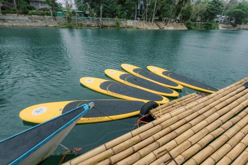 a group of kayaks lined up in the water at Loboc Riverside Inn & Restaurant in Loboc