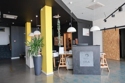 a lobby with a table and chairs and yellow walls at Hotel Ola - Adults Only in Trogir