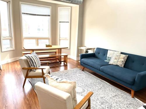 a living room with a blue couch and chairs at Beautiful Unit CHI in Prime River North - top floor in Chicago