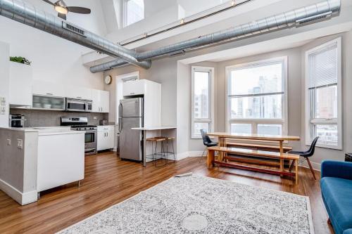 an open kitchen and living room with a blue couch at Beautiful Unit CHI in Prime River North - top floor in Chicago