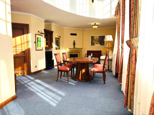 a dining room with a table and chairs at Hotel Opera in Sopot
