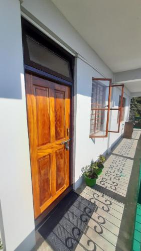 a wooden door on the side of a building at Norchuk Homestay in Jālāpahār