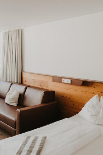 Ein Bett oder Betten in einem Zimmer der Unterkunft Hotel Hinteregger