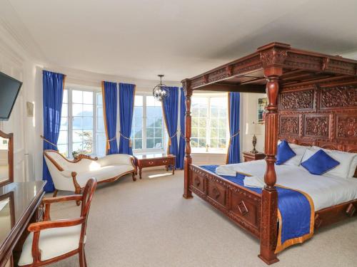 1 dormitorio con cama con dosel y cortinas azules en Bayview Tower, en Lynton