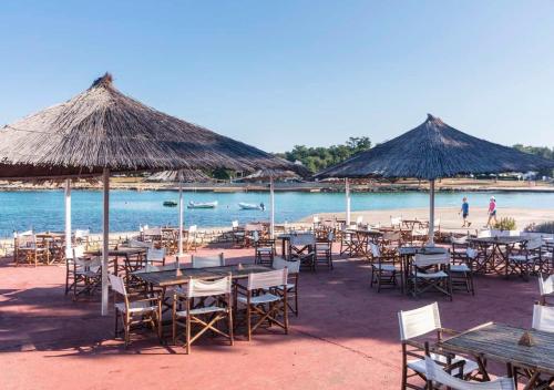 a group of tables and chairs on a beach at Camping Park Umag - Eurocamp I Homair in Umag