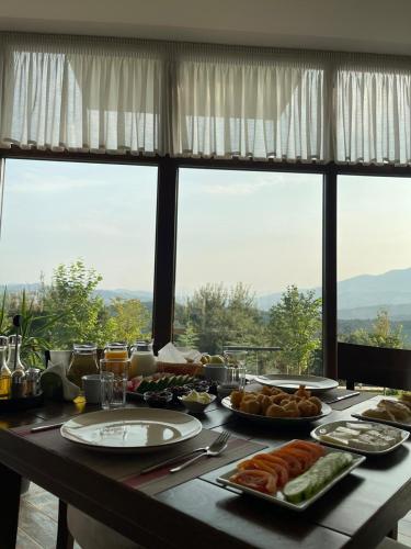 a table with plates of food on top of it at Gle-Alb AgroTourism in Tepelenë