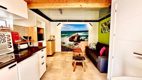 a kitchen with a living room with a view of the ocean at Cantinho do Pescador in Silveira