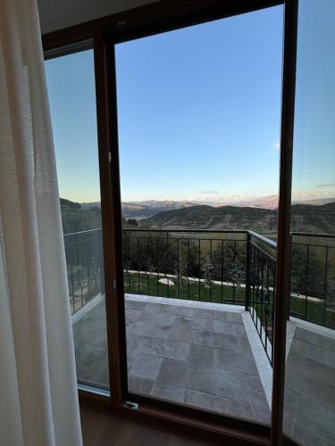 a view from the balcony of a room with sliding glass doors at Gle-Alb AgroTourism in Tepelenë