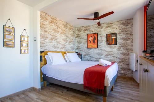 une chambre avec un lit et un mur de briques dans l'établissement Le Grand Moulin - Hypercentre - Lit King Size, à Corbeil-Essonnes
