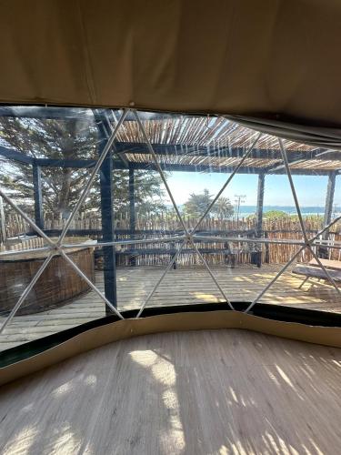 a view from the inside of a window with a deck at Domos de Matanzas in Matanzas