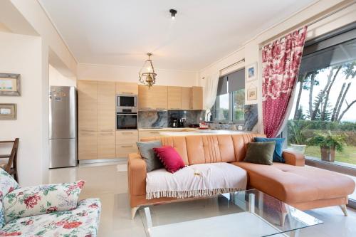 a living room with a couch and a kitchen at Celeste Sea View Apartment Hot Tub 18 plus Adults only in Psalidi