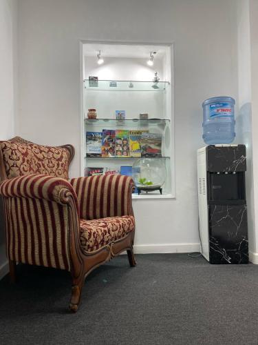 a living room with a couch and an open refrigerator at RUNO inn Hotel in Baku