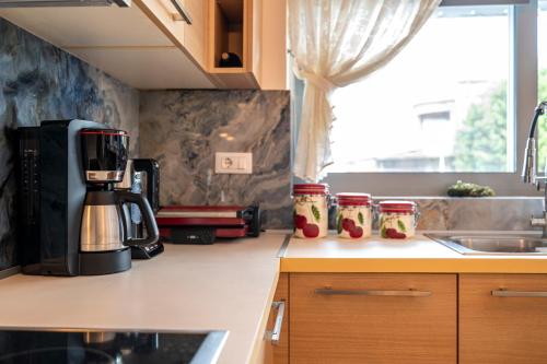 a kitchen with a coffee maker on a counter at Celeste Sea View Apartment Hot Tub 18 plus Adults only in Psalidi