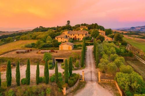 una casa en una colina con una carretera y árboles en Pool Villa Volterra by Villaflair, en Volterra
