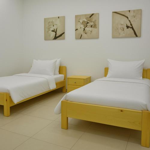 two beds sitting next to each other in a room at Atlas Royale Marrakech in Marrakesh