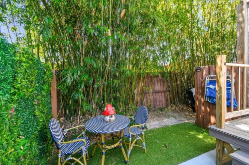 a table and chairs in a backyard with a fence at Designer Sun Filled Condo - Walk to Town in St Petersburg