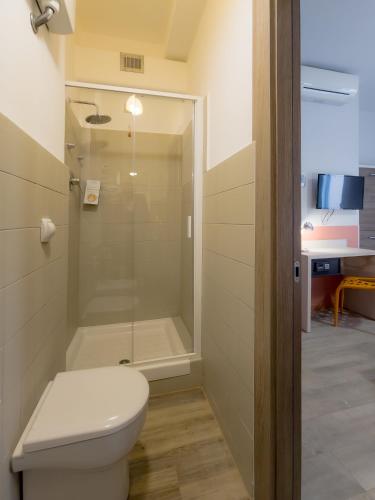 a bathroom with a toilet and a shower at Hotel Nologo in Genova